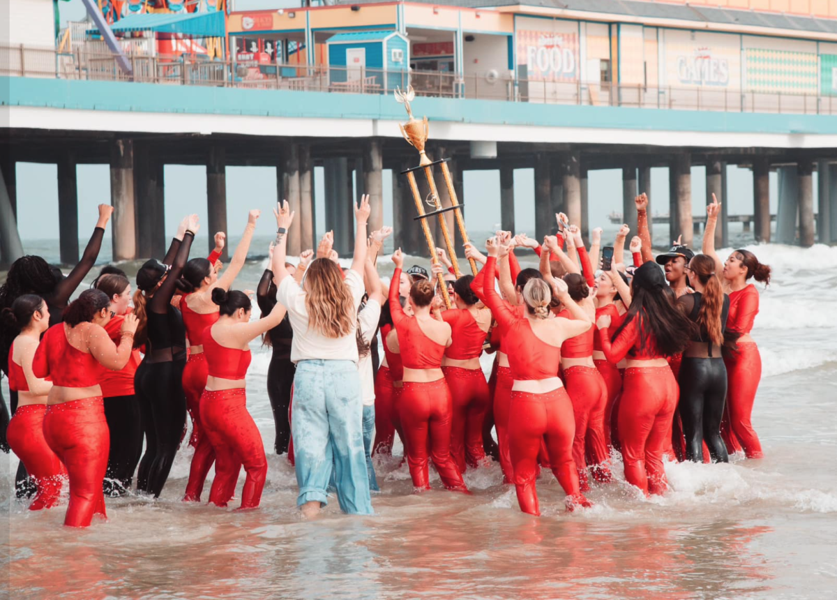 The Silver Spurs celebrate their Nationals win on a Galveston beach on March 30.